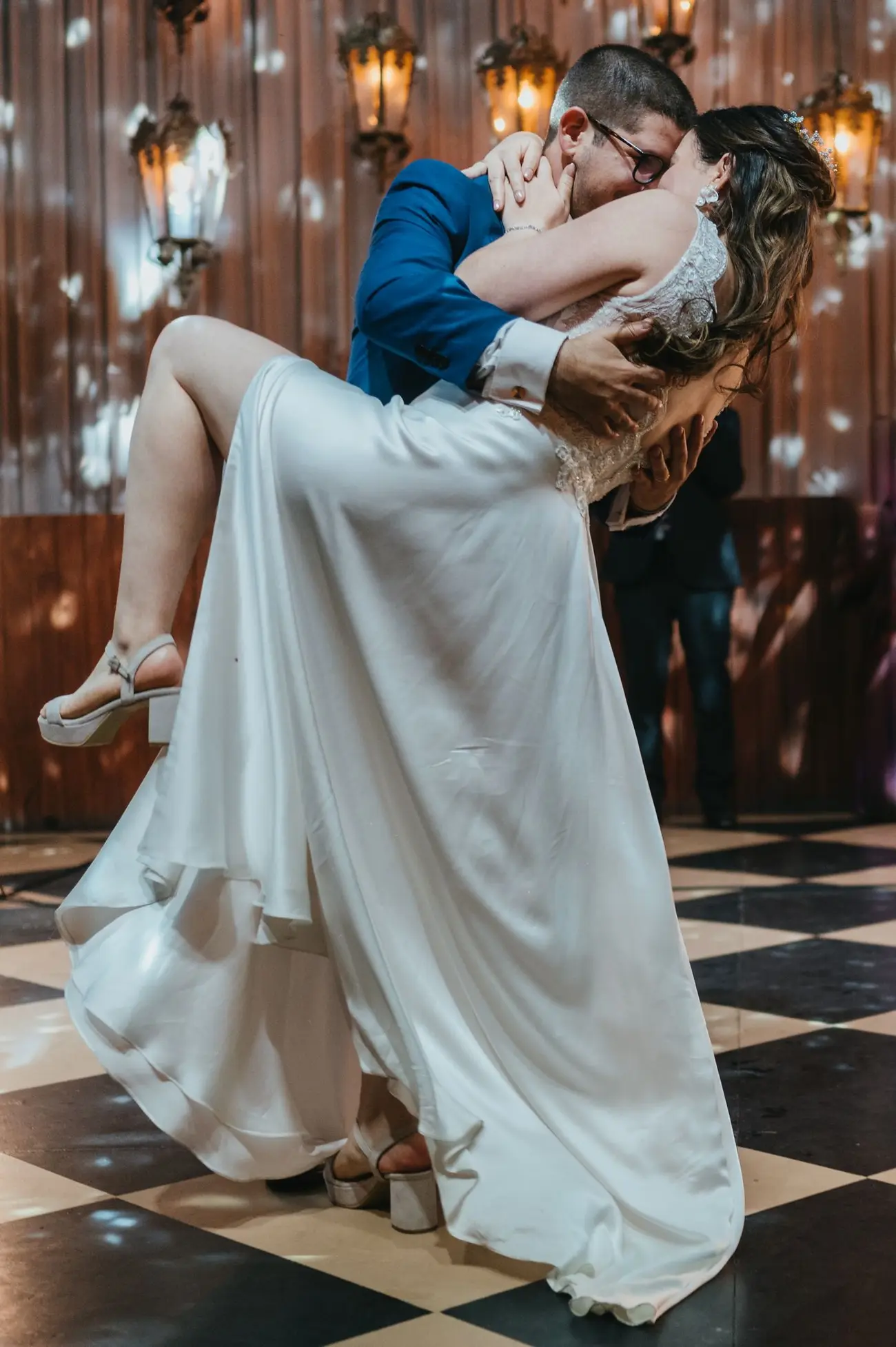The couple dancing as the family cheers
