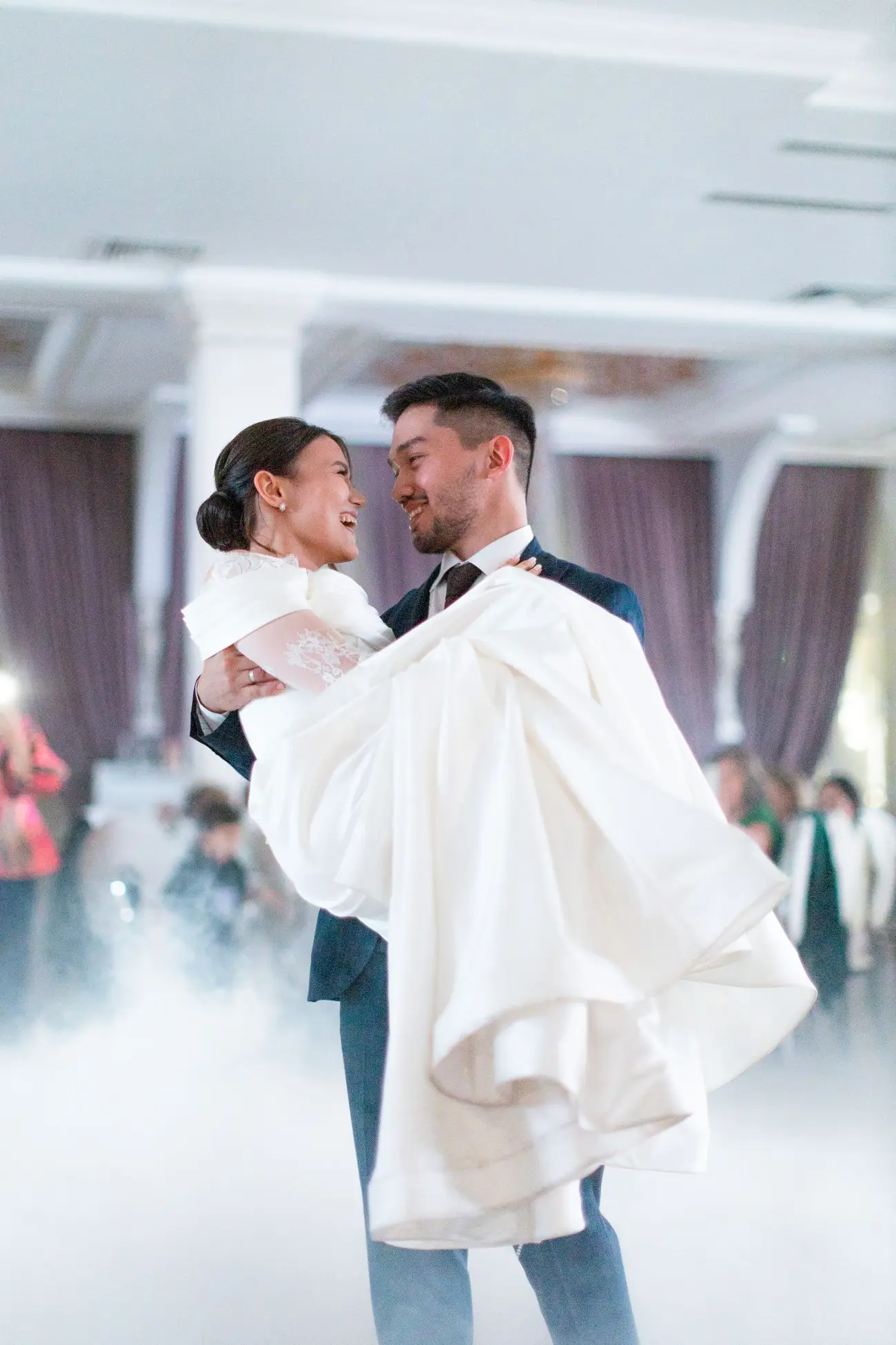 The couple mid turn on the dance floor, her gown sweeping out behind her