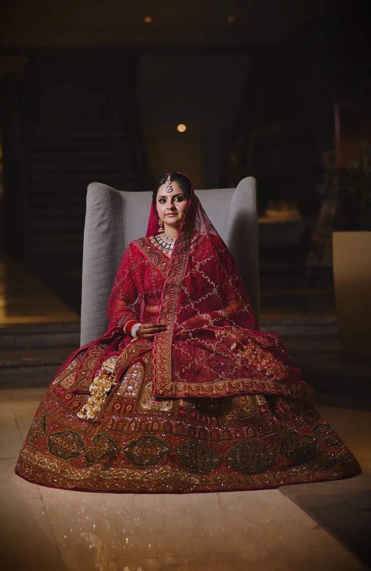 The bride seated in her embroidered bridal dress