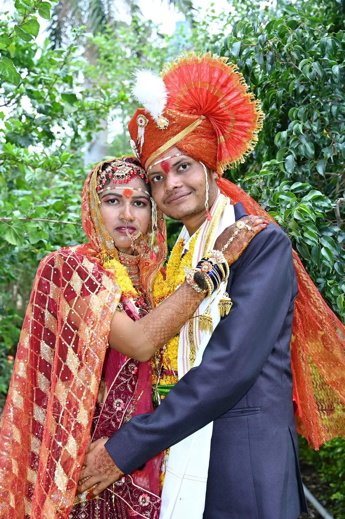The couple garlanded and glowing after the ceremony